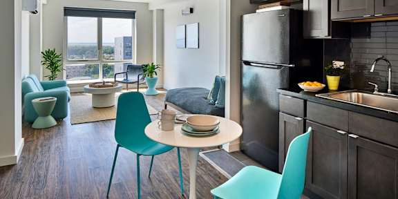 A modern kitchen with a dining table and chairs.
