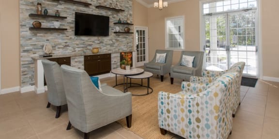 a living room filled with furniture and a large stone fireplace