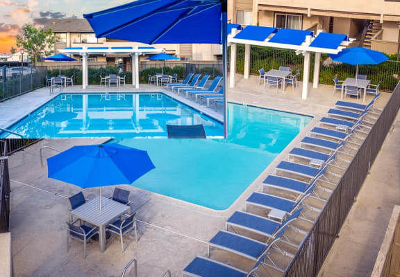 swimming pool with blue umbrellas and chairs around it at Sunstone Place, Riverside, CA