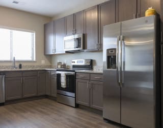 Open kitchen with gray cabinetry
