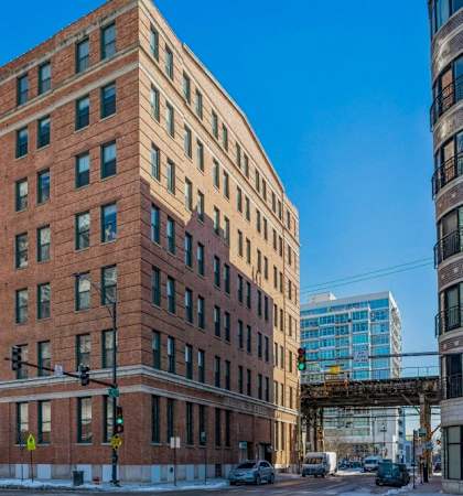 a tall brick building on a city street