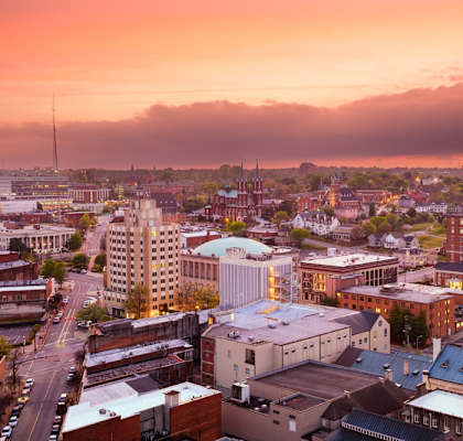 A cityscape with a church steeple stands out among the buildings.