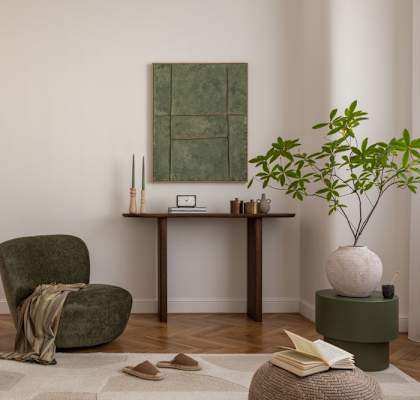 A living room with a green chair and a green table.