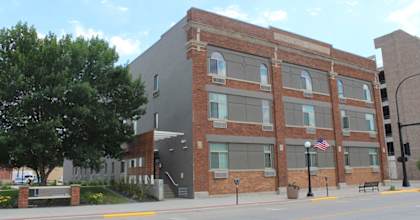 A brick building with a flag on the front.