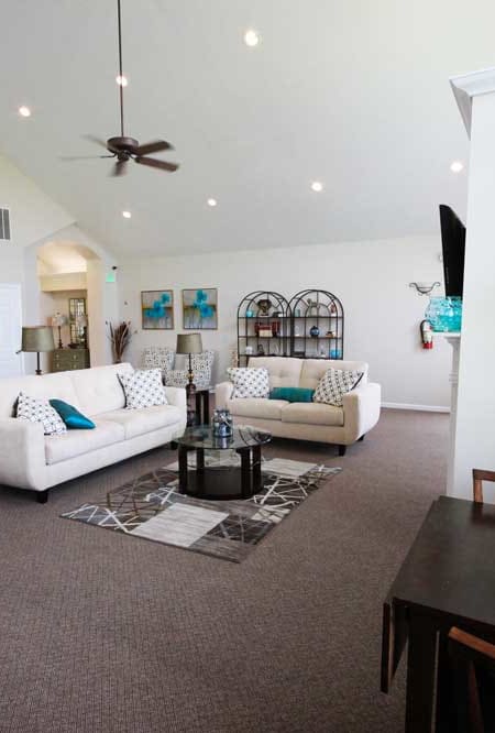 clubhouse lounge area with couches and a small table at canterbury house apartments in kalamazoo mi