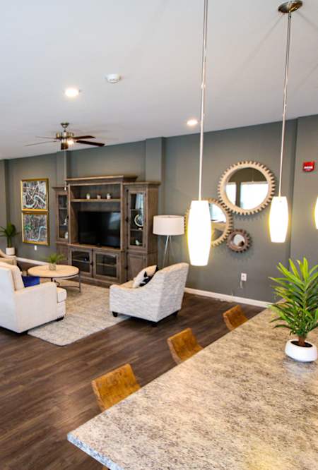 A living room with a dark wood floor and furniture.