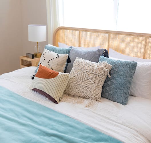a bedroom with a bed with pillows on it