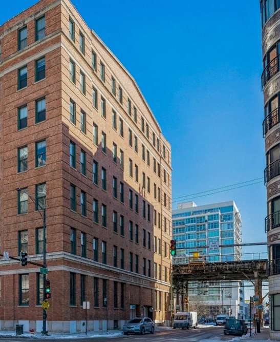 a tall brick building on a city street