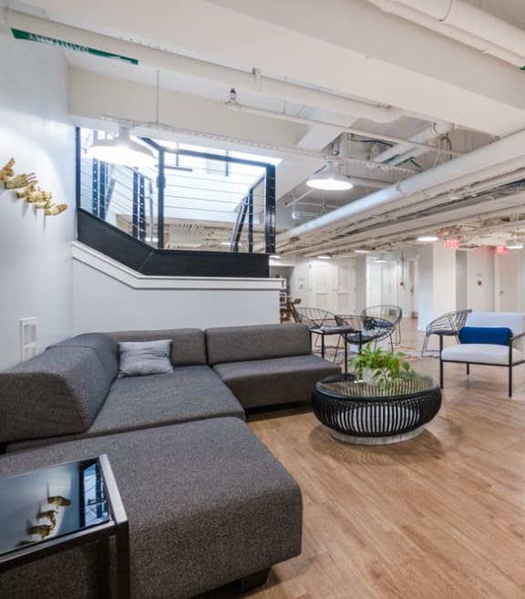a room with couches chairs and a staircase