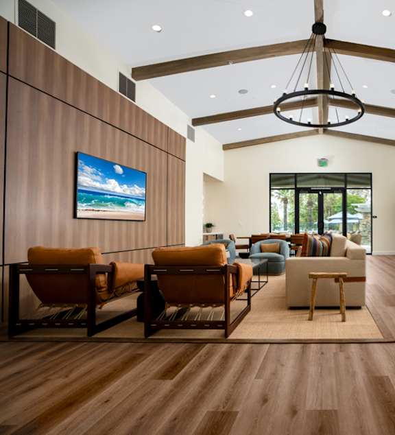 a large living room with furniture and a chandelier