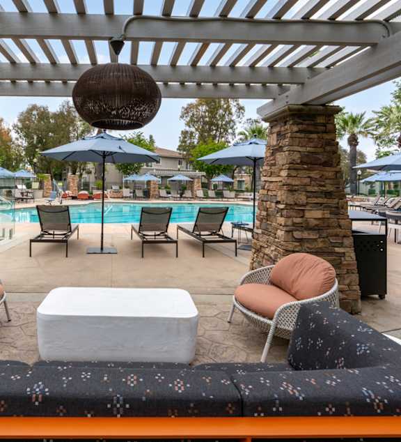 a poolside lounge area with chairs and a table