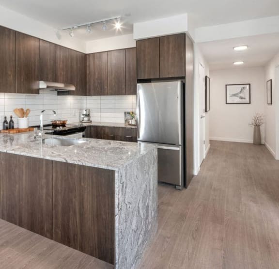 a kitchen with a marble counter top and a sink