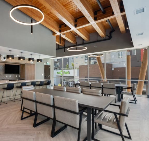 a dining room with a table and chairs and a kitchen