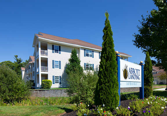 a large white apartment building with a sign that reads abbott landing