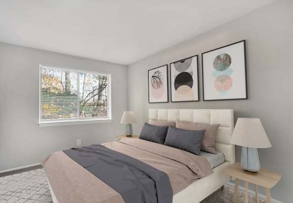 A bedroom with a large bed and three framed pictures on the wall.