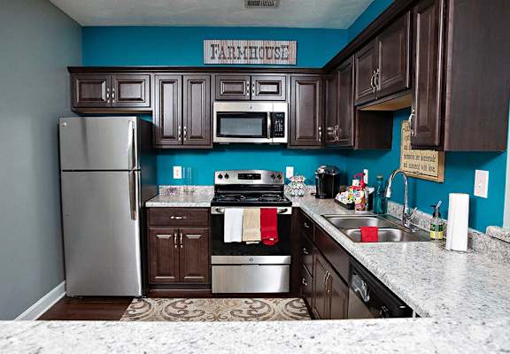 a kitchen with stainless steel appliances and wooden cabinets