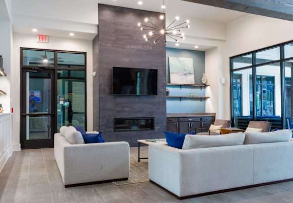A modern living room with a fireplace and a flat screen TV.