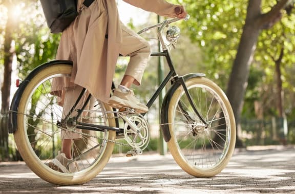 a woman riding a bike in a park
