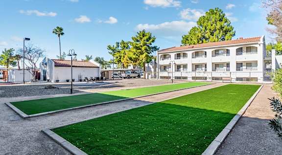 A sunny day at a park with a building in the background. at Tides on East Cactus Apartments, Phoenix