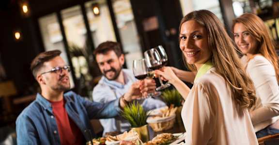 people drinking wine at a restaurant