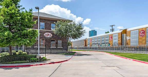 A LePon sign is on a building and a fence.