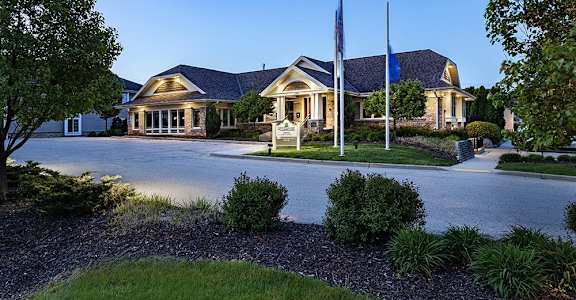 a house with a driveway and a flagpole in front of it