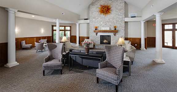 a large living room with furniture and a fireplace