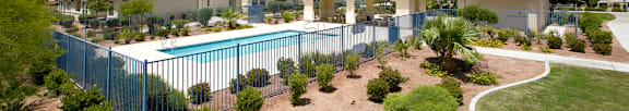 A pool area with a building in the background.
