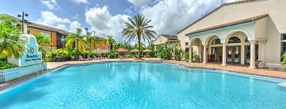 the master bedroom features a king sized bed and a flat screen tv at Hacienda Club Apartments in Jacksonville, FL