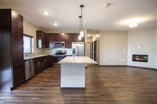 Apartment Interior Kitchen and living room with hardwood-style flooring at 360 at Jordan West