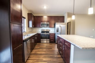 Kitchen with large island and granite counter tops at 360 at Jordan West