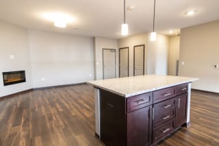 Kitchen island and living room space at 360 at Jordan West