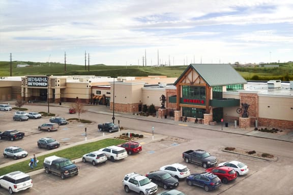 a shopping center with cars parked in front of it