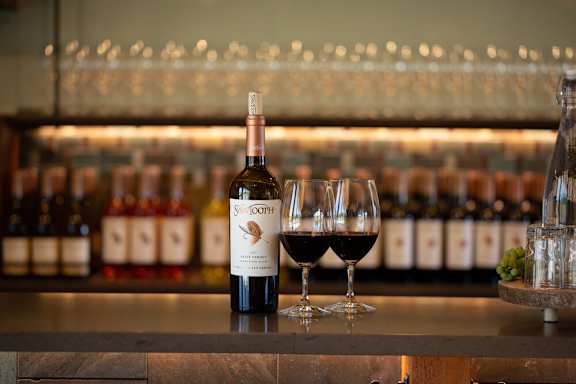 A bottle of Swan Oak wine is on a bar counter with two glasses of wine.at Alante Homes at Spring Run, Caldwell Idaho