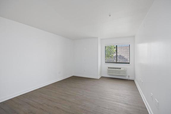 A room with a window and a radiator on the wall.