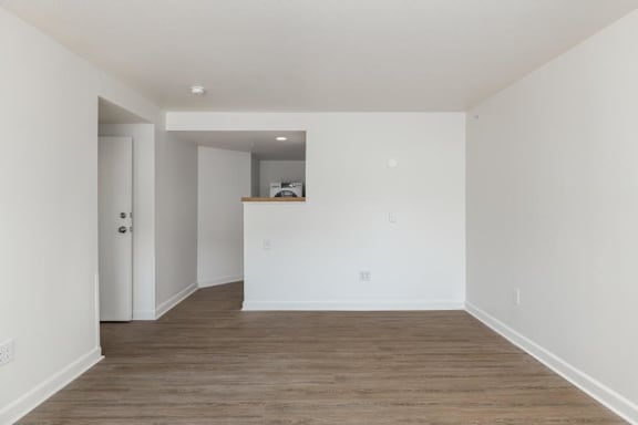 A room with white walls and wooden flooring.