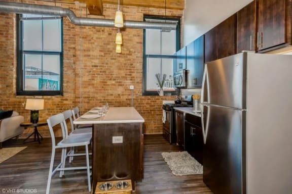 a kitchen and dining area in a 555 waverly unit at Carriage House Lofts, Chicago, IL