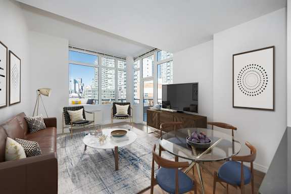 A living room with a brown couch, a glass table, and a television at The Maximilian Apartments, Long Island City, NY