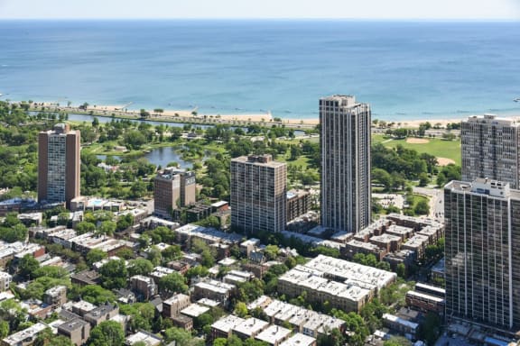 an aerial view of the city with the ocean in the background