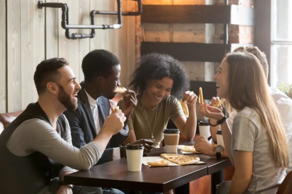 a group of people sitting around a table eating pizza at Griffin Weston, Cary, North Carolina