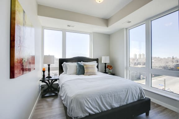 a bedroom with a bed and a large window