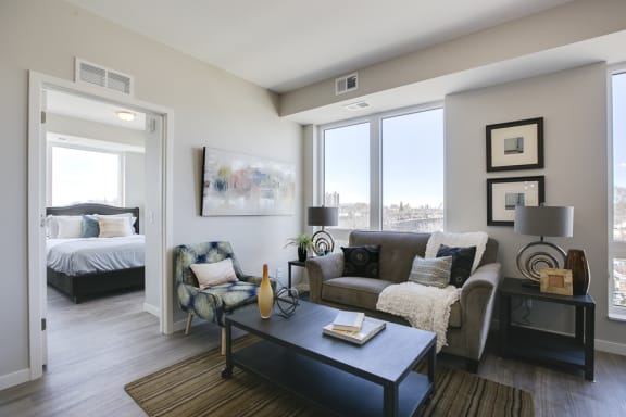 a living room with a couch and a coffee table and a bedroom with a bed