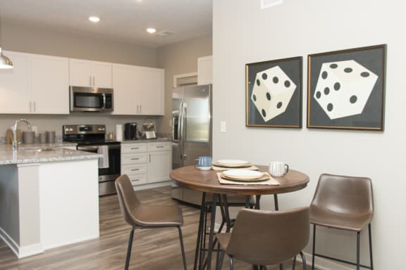 kitchen with white cabinets and dining area of to the side