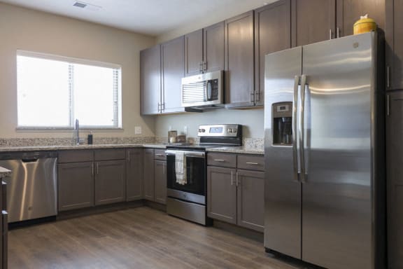 Open kitchen with gray cabinetry