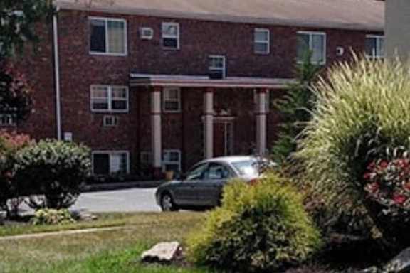 a car parked in front of an apartment building