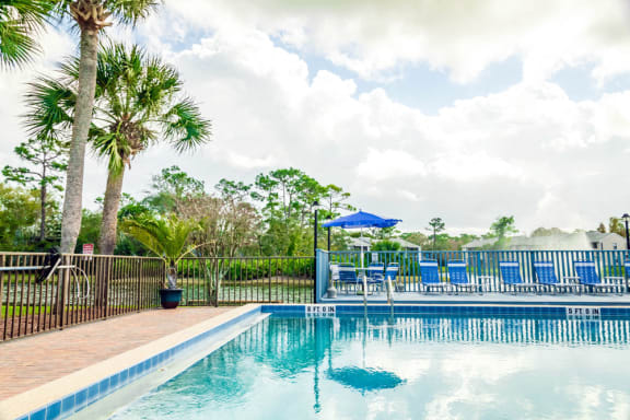 Outdoor swimming pool at Fishermans Landing apartments in Ormond Beach, FL