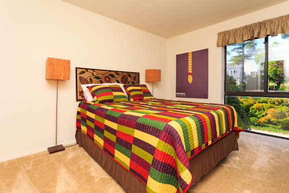 a bedroom with a bed and a large window at The Residences at the Manor Apartments, Frederick, 21702