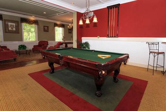 a pool table in the middle of a room at The Residences at the Manor Apartments, Frederick, 21702