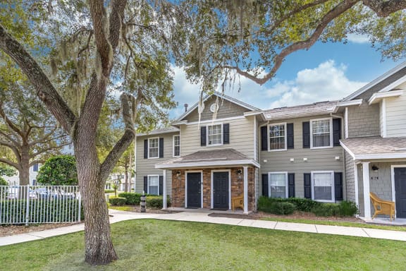 a large house with a tree in front of it