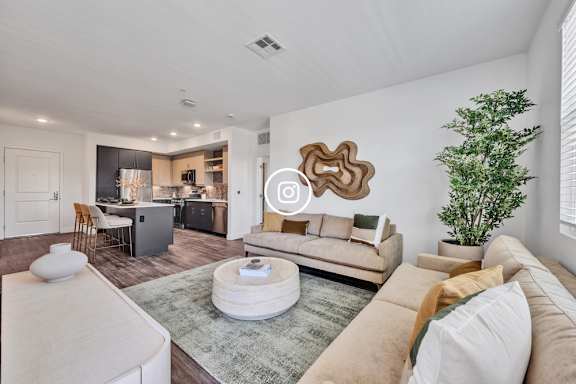 A modern living room with a white sofa and a grey rug.